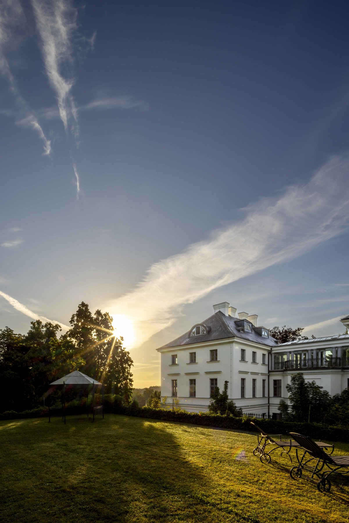 Hotel-Fotografie Mecklenburg-Vorpommern: Außenansicht von Burg Schlitz bei Sonnenuntergang.